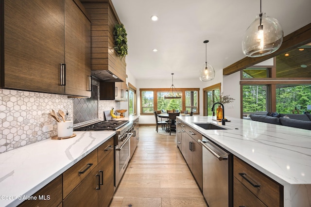 1230 E Amulet Cir, Rathdrum, ID 83858 - kitchen featuring appliances with stainless steel finishes, a sink, light wood-style flooring, decorative backsplash, and recessed lighting