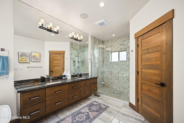 1230 E Amulet Cir, Rathdrum, ID 83858 - full bathroom featuring a shower stall, double vanity, and a chandelier