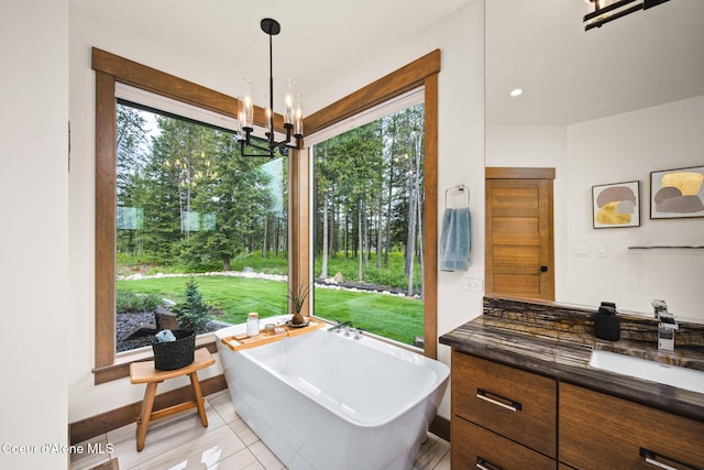 1230 E Amulet Cir, Rathdrum, ID 83858 - full bath featuring a chandelier, a soaking tub, vanity, and tile patterned flooring
