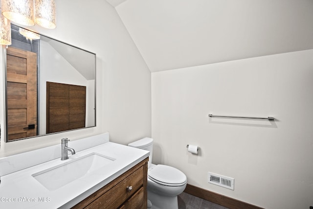 1230 E Amulet Cir, Rathdrum, ID 83858 - bathroom with vaulted ceiling, toilet, vanity, and baseboards