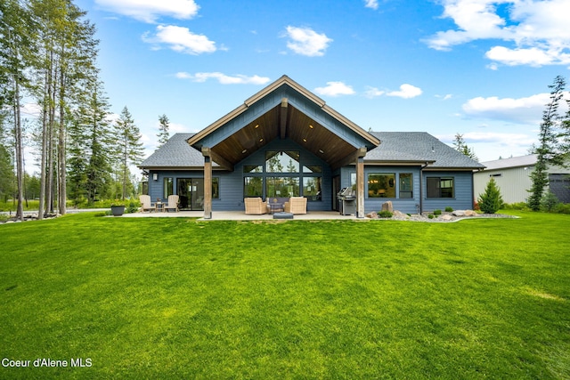 1230 E Amulet Cir, Rathdrum, ID 83858 - rear view of property featuring a patio area, outdoor lounge area, a yard, and roof with shingles