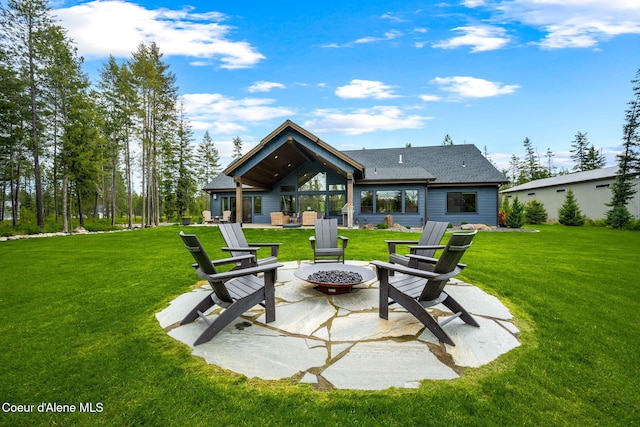 1230 E Amulet Cir, Rathdrum, ID 83858 - back of property with an outdoor fire pit, a patio area, a yard, and roof with shingles