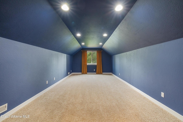 27464 N Timber Ridge Rd, Rathdrum, ID 83858 - bonus room with carpet, lofted ceiling, a textured wall, recessed lighting, and baseboards
