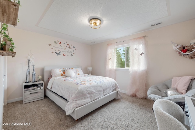 27464 N Timber Ridge Rd, Rathdrum, ID 83858 - bedroom featuring light colored carpet, a textured ceiling, and baseboards