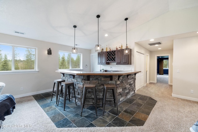 27464 N Timber Ridge Rd, Rathdrum, ID 83858 - indoor wet bar featuring baseboards, lofted ceiling, decorative light fixtures, recessed lighting, and dark carpet