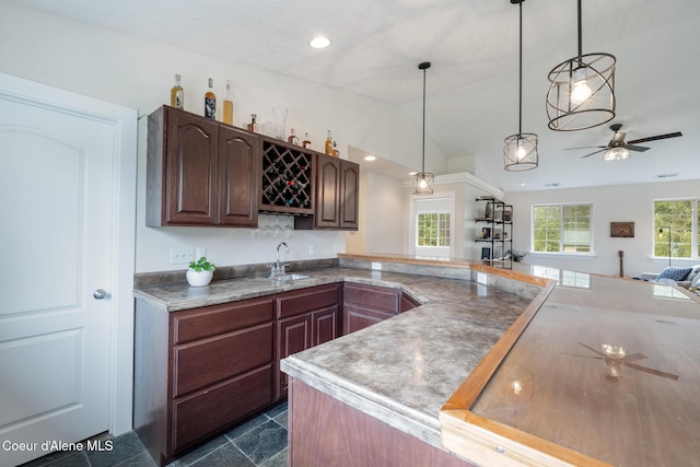 27464 N Timber Ridge Rd, Rathdrum, ID 83858 - kitchen featuring a sink, lofted ceiling, a ceiling fan, hanging light fixtures, and open floor plan