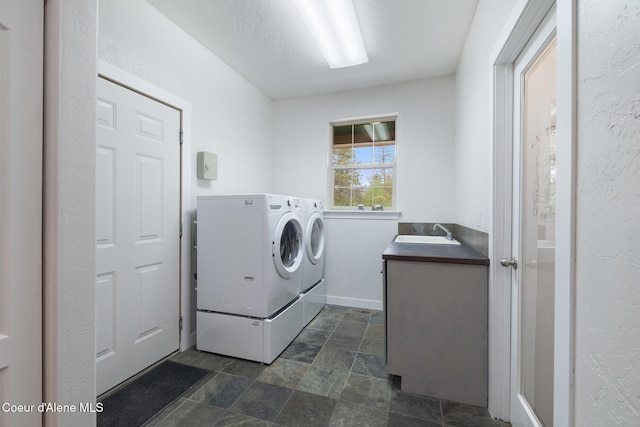 27464 N Timber Ridge Rd, Rathdrum, ID 83858 - laundry area with washing machine and dryer, stone finish flooring, and baseboards