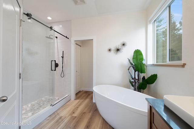 27464 N Timber Ridge Rd, Rathdrum, ID 83858 - bathroom featuring wood finished floors, a stall shower, a soaking tub, vanity, and recessed lighting