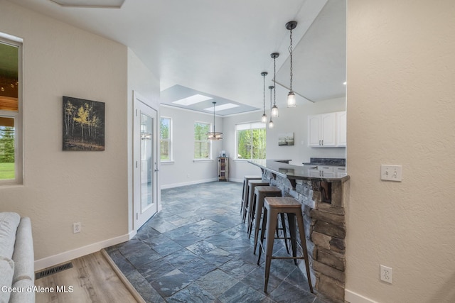 27464 N Timber Ridge Rd, Rathdrum, ID 83858 - dining space with baseboards, dark stone finish flooring, and a textured wall
