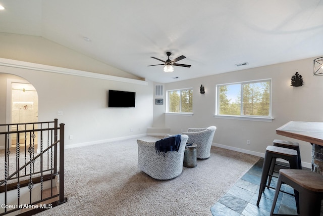 27464 N Timber Ridge Rd, Rathdrum, ID 83858 - carpeted living room with vaulted ceiling, a ceiling fan, arched walkways, and baseboards