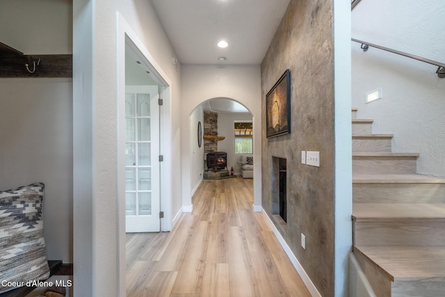 27464 N Timber Ridge Rd, Rathdrum, ID 83858 - corridor with arched walkways, light wood-style flooring, stairs, and recessed lighting