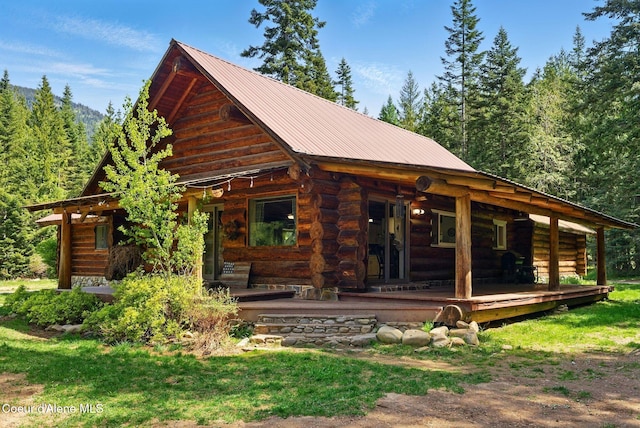 back of property featuring metal roof and log siding