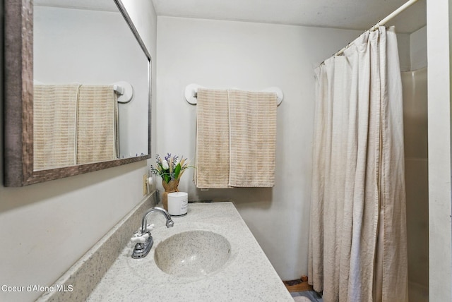 bathroom featuring vanity and curtained shower