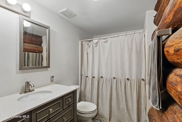 bathroom with toilet, vanity, a shower with curtain, and wood finished floors
