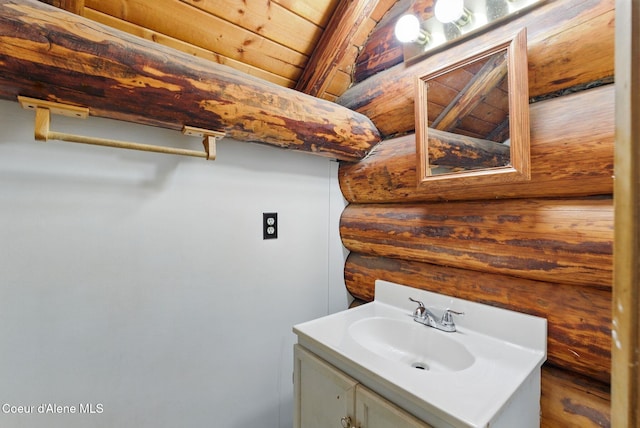 bathroom with vanity and log walls