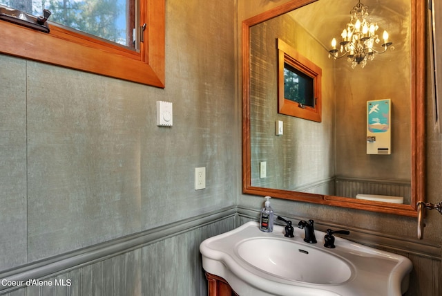 7177 W Heine Rd, Coeur Dalene, ID 83814 - half bathroom with a chandelier and vanity