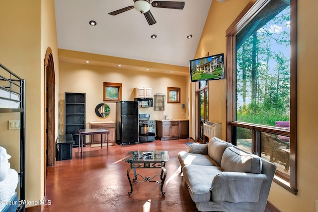 7177 W Heine Rd, Coeur Dalene, ID 83814 - living area with plenty of natural light, high vaulted ceiling, a ceiling fan, recessed lighting, and concrete floors