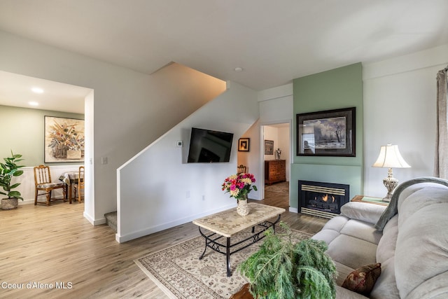 377 E Knotty Pine Ln Unit 2, Coeur Dalene, ID 83815 - living room featuring wood finished floors, baseboards, a lit fireplace, and recessed lighting