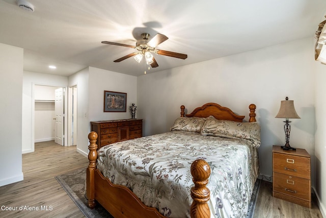 377 E Knotty Pine Ln Unit 2, Coeur Dalene, ID 83815 - bedroom with light wood-style flooring, baseboards, a ceiling fan, and a walk in closet