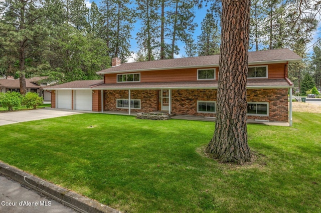 279 S Sequoia Ct, Post Falls, ID 83854 - view of front of home featuring a chimney, driveway, an attached garage, a front lawn, and brick siding