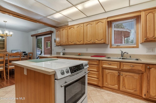 279 S Sequoia Ct, Post Falls, ID 83854 - kitchen with range with electric stovetop, a sink, light tile patterned floors, light countertops, and pendant lighting