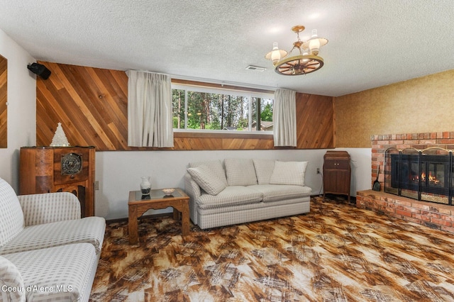 279 S Sequoia Ct, Post Falls, ID 83854 - living area featuring a textured ceiling, a chandelier, wooden walls, a fireplace, and wood finished floors