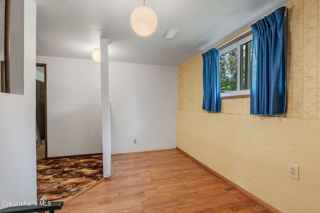 279 S Sequoia Ct, Post Falls, ID 83854 - below grade area featuring wood finished floors and wallpapered walls
