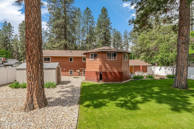 279 S Sequoia Ct, Post Falls, ID 83854 - back of house featuring a storage shed, an outdoor structure, a patio, and a shingled roof