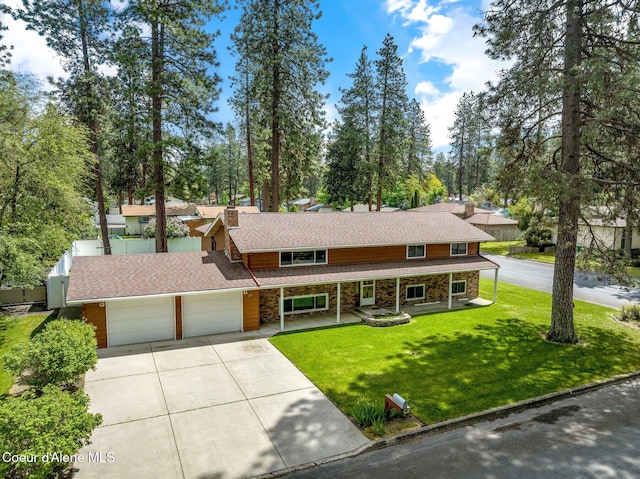 279 S Sequoia Ct, Post Falls, ID 83854 - view of front facade featuring concrete driveway, covered porch, a garage, a front yard, and stone siding