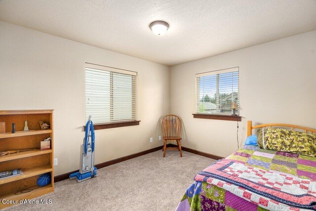 1761 W Pyrenees Loop, Coeur Dalene, ID 83815 - bedroom featuring carpet flooring and baseboards