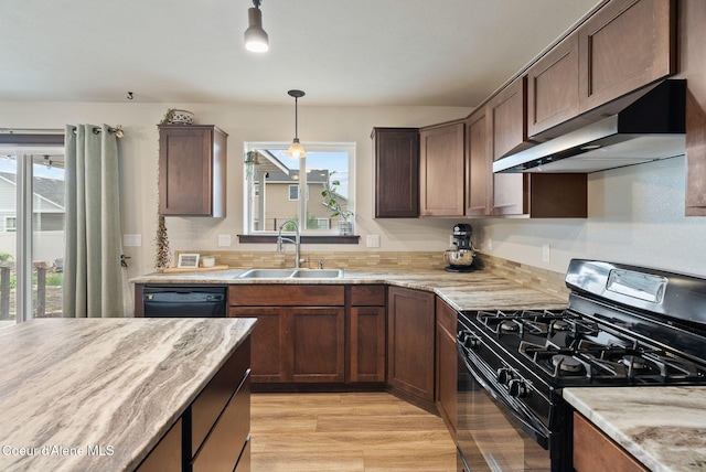 6595 W Covenant St, Rathdrum, ID 83858 - kitchen featuring black appliances, a sink, under cabinet range hood, light wood-type flooring, and pendant lighting