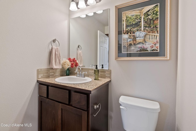 6595 W Covenant St, Rathdrum, ID 83858 - bathroom with vanity, toilet, and tasteful backsplash