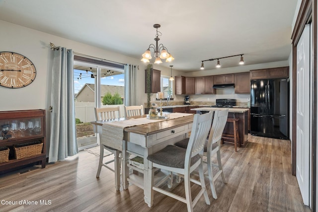 6595 W Covenant St, Rathdrum, ID 83858 - dining room featuring light wood-style floors, rail lighting, and a chandelier