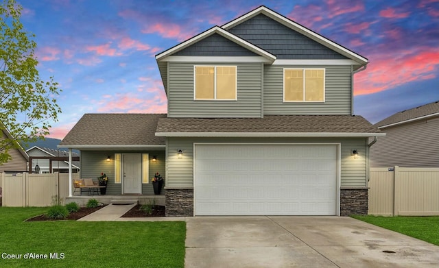 6595 W Covenant St, Rathdrum, ID 83858 - craftsman-style house featuring a porch, stone siding, a garage, and driveway