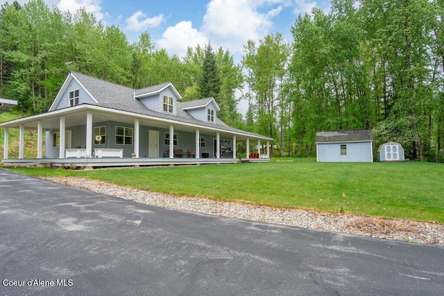911 French Gulch Rd, Kingston, ID 83839 - country-style home featuring a porch, a storage shed, an outbuilding, and a front yard