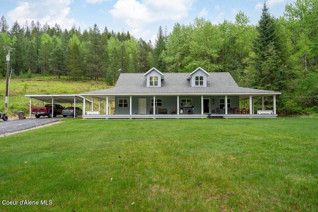 911 French Gulch Rd, Kingston, ID 83839 - back of house with a porch, a lawn, driveway, and a view of trees