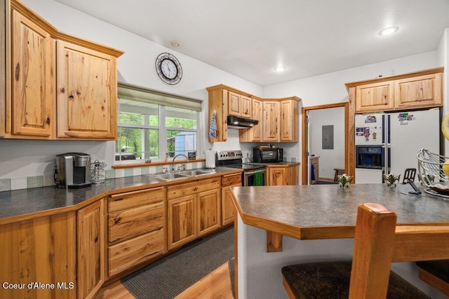 911 French Gulch Rd, Kingston, ID 83839 - kitchen with stainless steel electric range oven, a sink, white refrigerator with ice dispenser, under cabinet range hood, and dark countertops