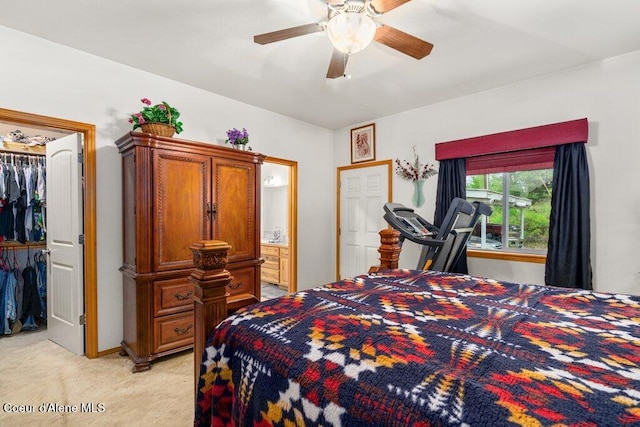 911 French Gulch Rd, Kingston, ID 83839 - bedroom with light colored carpet, a spacious closet, a ceiling fan, and connected bathroom