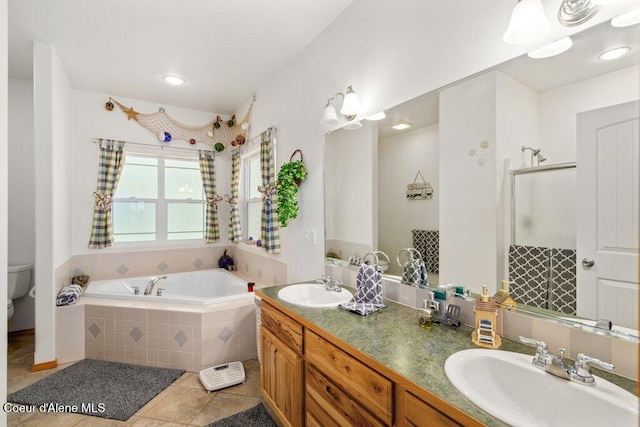 911 French Gulch Rd, Kingston, ID 83839 - full bath with tile patterned flooring, a bath, toilet, double vanity, and an enclosed shower