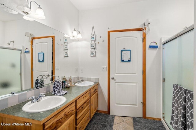 911 French Gulch Rd, Kingston, ID 83839 - bathroom with tile patterned flooring, a stall shower, double vanity, and baseboards