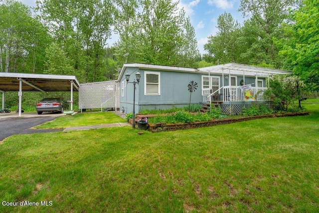911 French Gulch Rd, Kingston, ID 83839 - manufactured / mobile home featuring driveway, a front lawn, and a carport