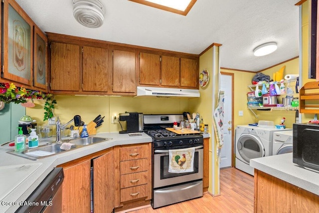 911 French Gulch Rd, Kingston, ID 83839 - kitchen featuring appliances with stainless steel finishes, separate washer and dryer, under cabinet range hood, a sink, and light wood-style floors