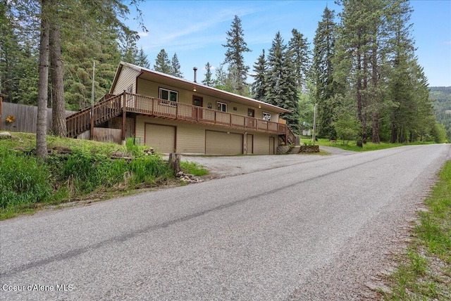 1072 Upland Dr, Sandpoint, ID 83864 - view of front of property with stairway, an attached garage, and driveway