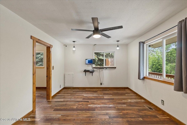 1072 Upland Dr, Sandpoint, ID 83864 - empty room featuring wood finished floors, ceiling fan, a textured ceiling, and baseboards
