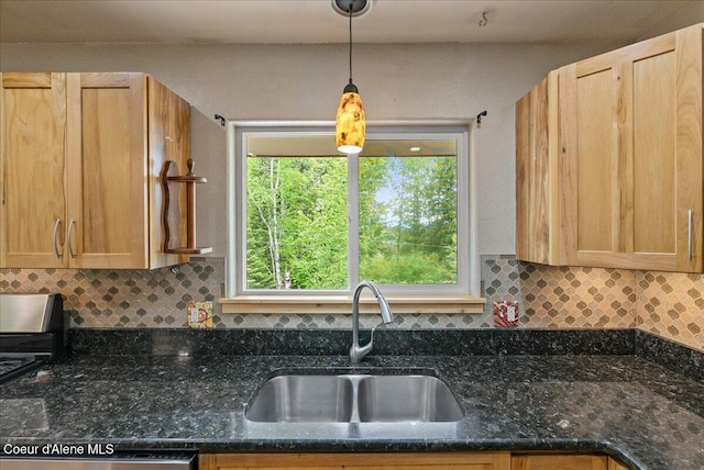 1072 Upland Dr, Sandpoint, ID 83864 - kitchen with a sink, tasteful backsplash, decorative light fixtures, and dark stone counters