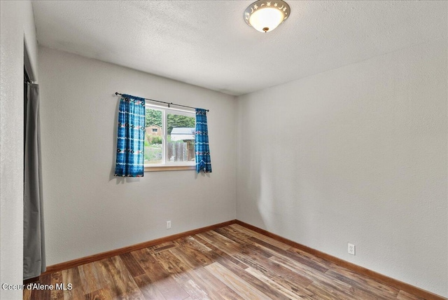 1072 Upland Dr, Sandpoint, ID 83864 - empty room featuring wood finished floors and baseboards