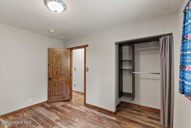 1072 Upland Dr, Sandpoint, ID 83864 - unfurnished bedroom with a closet, wood finished floors, and baseboards