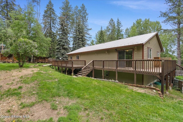 1072 Upland Dr, Sandpoint, ID 83864 - rear view of house with stairway, a deck, a yard, and metal roof