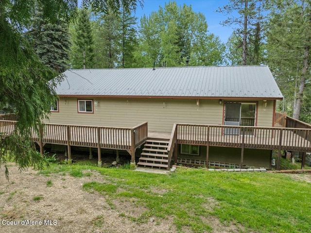 1072 Upland Dr, Sandpoint, ID 83864 - rear view of house featuring a wooden deck, metal roof, and a yard