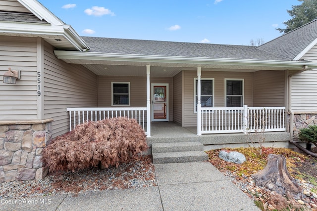 5519 N Wade St, Coeur Dalene, ID 83815 - view of exterior entry featuring a porch and roof with shingles
